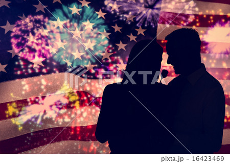 Composite image of handsome man giving his wife a pink rose 16423469