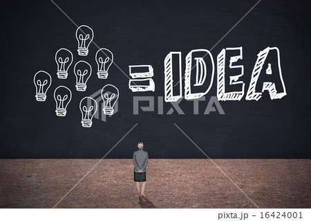 Composite image of businesswoman standing with hands behind back 16424001