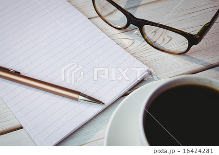 Empty notepad with reading glasses and cup of coffee 16424281