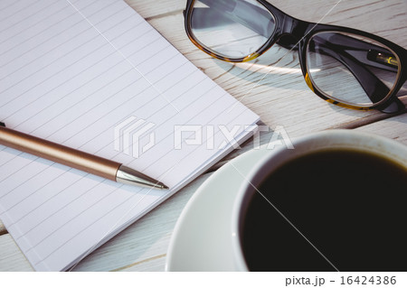 Empty notepad with reading glasses and cup of coffee 16424386