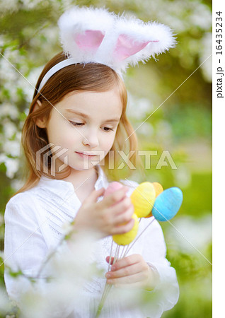 Adorable little girl wearing bunny ears on Easter 16435234