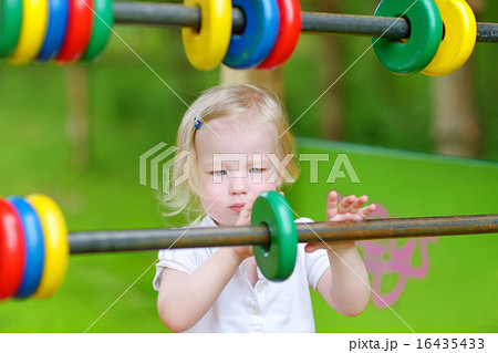 Toddler girl having fun at a playground 16435433