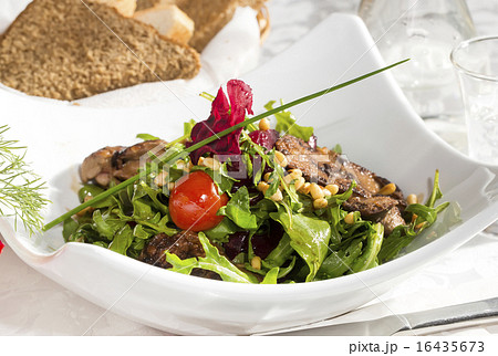 rabbit liver salad with arugula in a restaurant 16435673