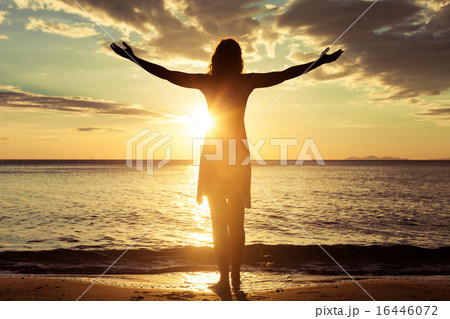 woman open arms under the sunrise at sea 16446072