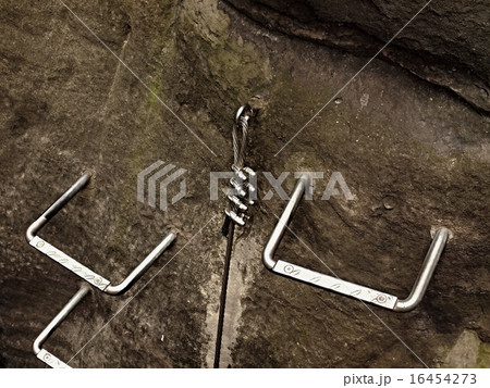 Climbers ladder. Iron twisted rope fixed in rock Climbers ladder. Iron twisted rope fixed in rock 16454273