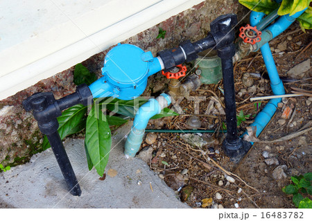 Old and dirty tab water pipe and meter on ground 16483782