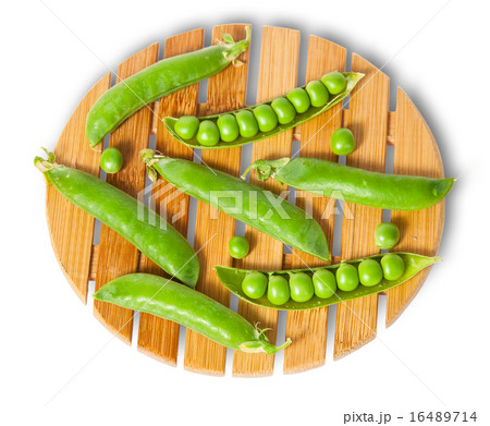 Pods of peas on bamboo board top and front view 16489714