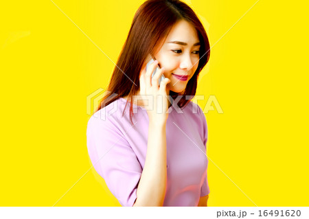 携帯電話をかけるアジアの若い女性会社員 携帯電話をかけるアジアの若い女性会社員 16491620