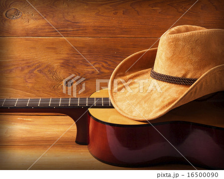 Guitar and cowboy hat on wood background 16500090
