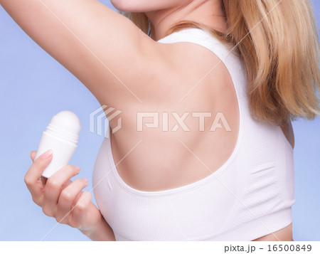 Girl applying stick deodorant in armpit. Skin care Girl applying stick deodorant in armpit. Skin care 16500849