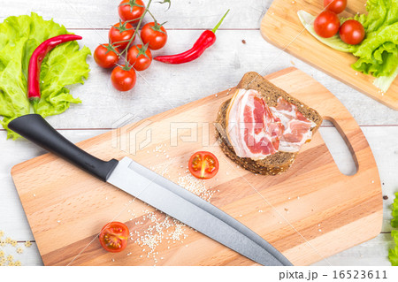Tomato, toasts, meat and salad on wooden table Tomato, toasts, meat and salad on wooden table 16523611