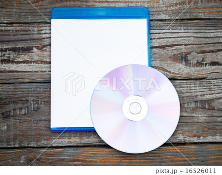 Blank compact disc with cover on wood background ground 16526011