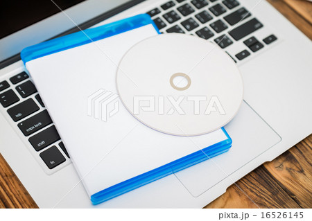 Blank compact disc with cover on laptop keyboard 16526145