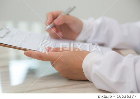 Hand of doctor writing on prescription 16526277