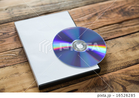Blank compact disc with cover on wood background ground Blank compact disc with cover on wood background ground 16526285