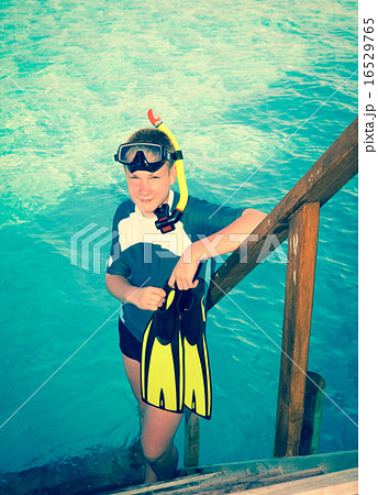 teenager with flippers, mask and tube at ocean. .M 16529765