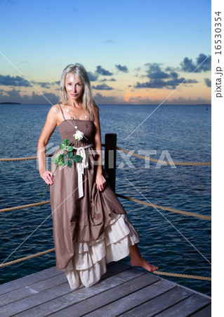young beautiful woman  on a wooden platform over   16530354