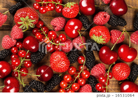 Collection of berries on wood background 16531064