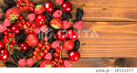 Collection of berries on wood background 16531077