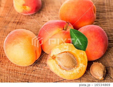 Apricots on the wooden background 16534869