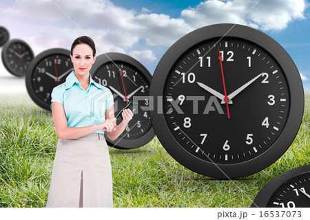Composite image of serious classy businesswoman using calculator 16537073