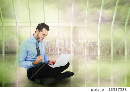 Composite image of cheering businessman sitting using his laptop Composite image of cheering businessman sitting using his laptop 16537528