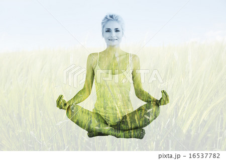 Composite image of toned young woman sitting in lotus pose 16537782