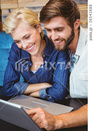 Cute couple on a date watching photos on a laptop 16541688