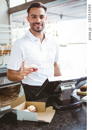 Smiling worker prepares orders 16541689
