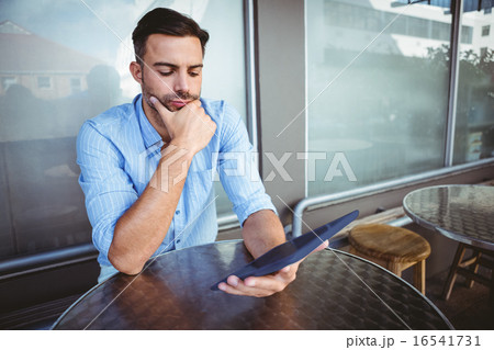 Attentive businessman using a tablet 16541731