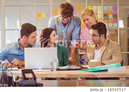 Happy creative business team using laptop in meeting Happy creative business team using laptop in meeting 16542517