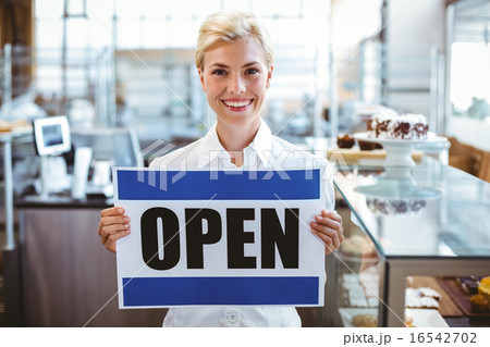 Cafe owner smiling at the camera 16542702