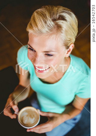 Pretty blonde holding cup of coffee 16542703