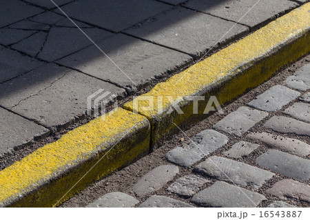 Yellow curb stone border Yellow curb stone border 16543887