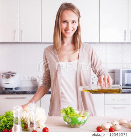 Young Woman Cooking in the kitchen. 16546575