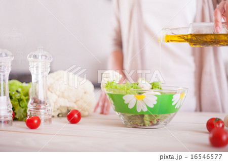 Young woman mixing fresh salad. Young woman mixing fresh salad. 16546577