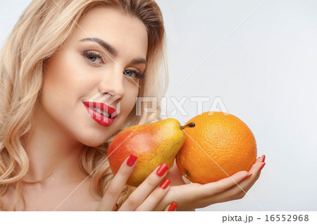 Attractive young girl with two tasty fruits 16552968