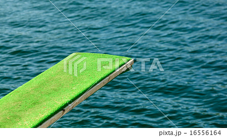 View of diving board. Springboard to dive at water. View of diving board. Springboard to dive at water. 16556164