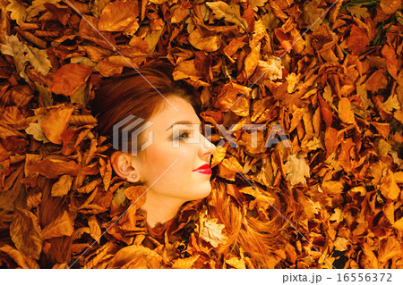 Portrait of young woman in autumn leaves. Portrait of young woman in autumn leaves. 16556372