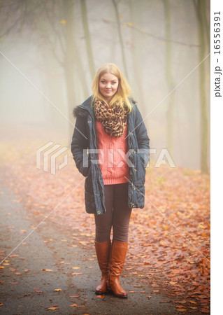 Woman walking in park in foggy day 16556391
