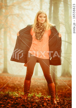 Woman walking in park in foggy day 16556623