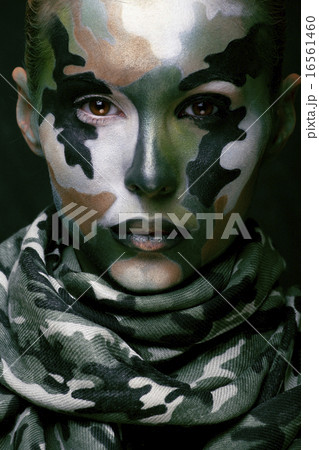 Beautiful young fashion woman with military style clothing and face paint make-up, khaki colors 16561460