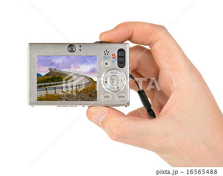 Hand with camera and Norway travel photo Hand with camera and Norway travel photo 16565488