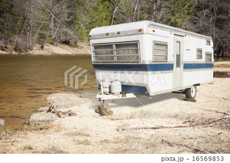 Classic Old Camper Trailer Near A River Classic Old Camper Trailer Near A River 16569853