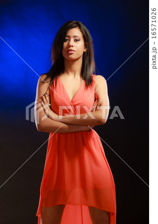 mixed race girl in party dress on blue 16571026