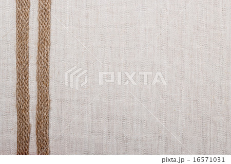 Jute ribbon on linen cloth background 16571031