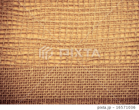 Jute ribbon on burlap cloth background 16571036