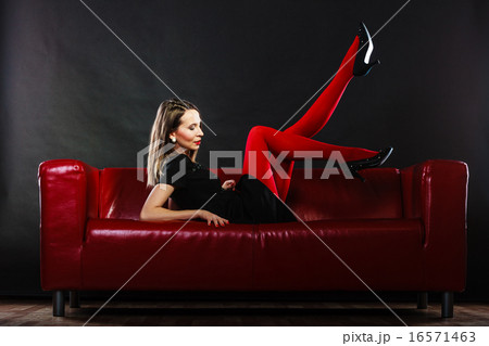 Fashion woman in red pantyhose on couch 16571463