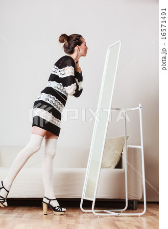 Woman trying dress shopping for clothing. 16571491