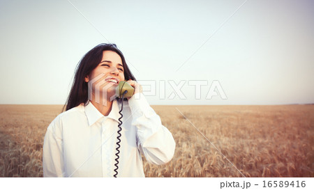 Young brunette girl with green dial handset Young brunette girl with green dial handset 16589416